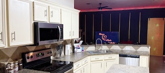 Adult-only kink-friendly getaway with Jacuzzi spa, king bed, custom play furniture, massage table, and LED mood lighting. Ideal for romantic escapes, adventurous weekends, or indulgent celebrations in total privacy.