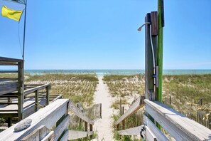 A wooden boardwalk leading to a beach with a clear view of the ocean. - Seaworthy - Dog Friendly, Updated Classic Cottage with Bonus Space! (Topsail Beach)