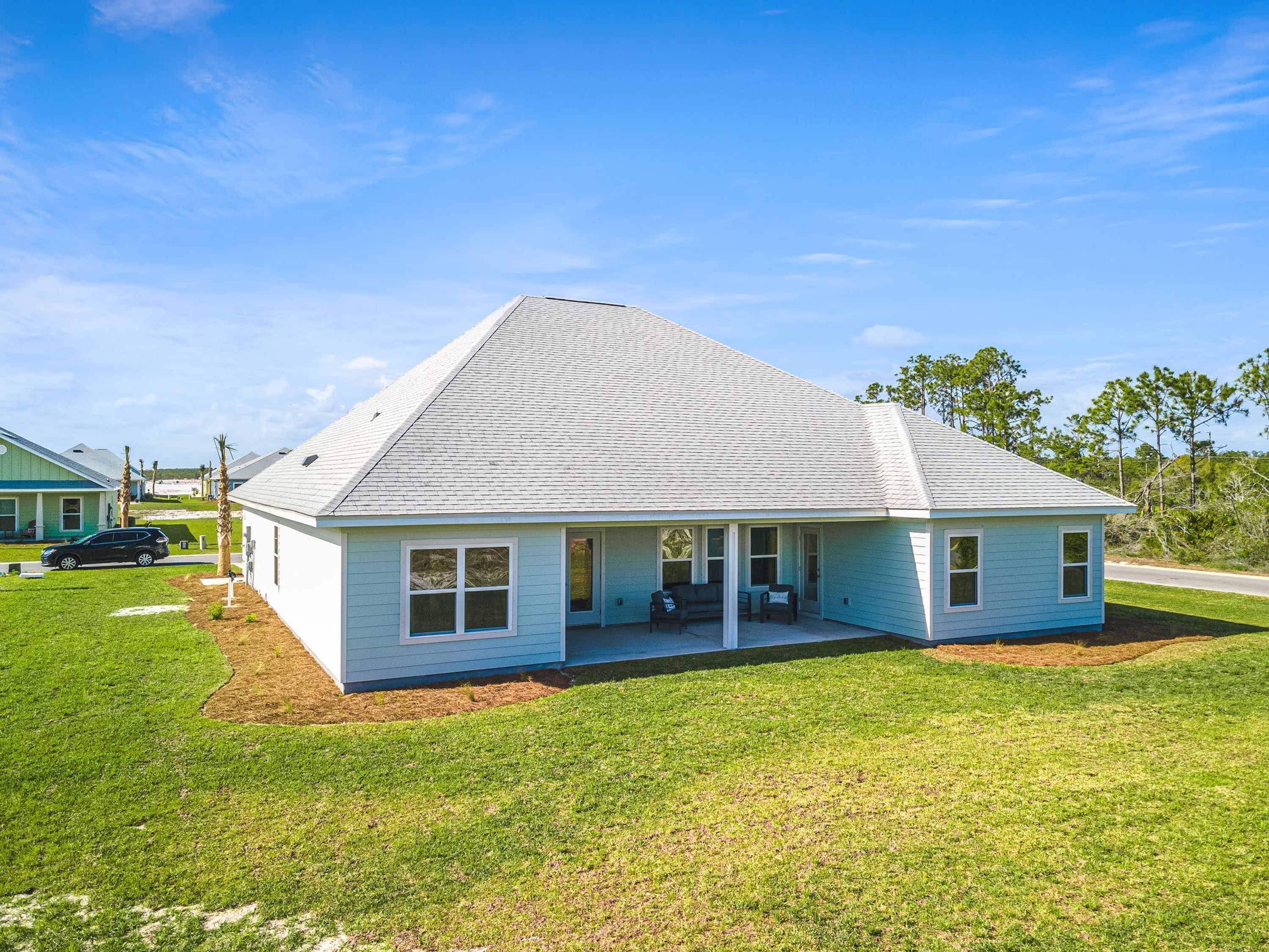 A single-story house with a gabled roof, a front porch, and a small attached garage.