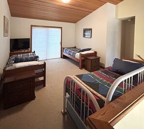 A bedroom with two beds, a TV, a dresser, and a closet. - Hot tub, Pet friendly, directly across from GM Rec Center (Black Butte Ranch)