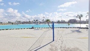 A beach volleyball court with a net, palm trees, and a clear blue sky. - Exclusive Penthouse in Santa Rosalia Lake & Life Resort El Caribe on the Costa Calida (Torre-Pacheco)