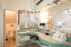 A bathroom with a curved sink, multiple mirrors, and a tiled floor. - Family Reunion Compound - Great for Groups! Large pool. (Key West)