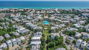 A coastal residential area with a central swimming pool surrounded by houses.