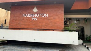 The exterior of Harrington Inn with a prominent sign, a modern design, and a gated entrance. - Harrington Inn  (Ibadan)