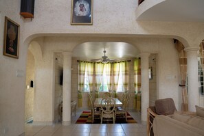 Enjoy meals in this traditional dining area with a wooden table and comfortable seating.