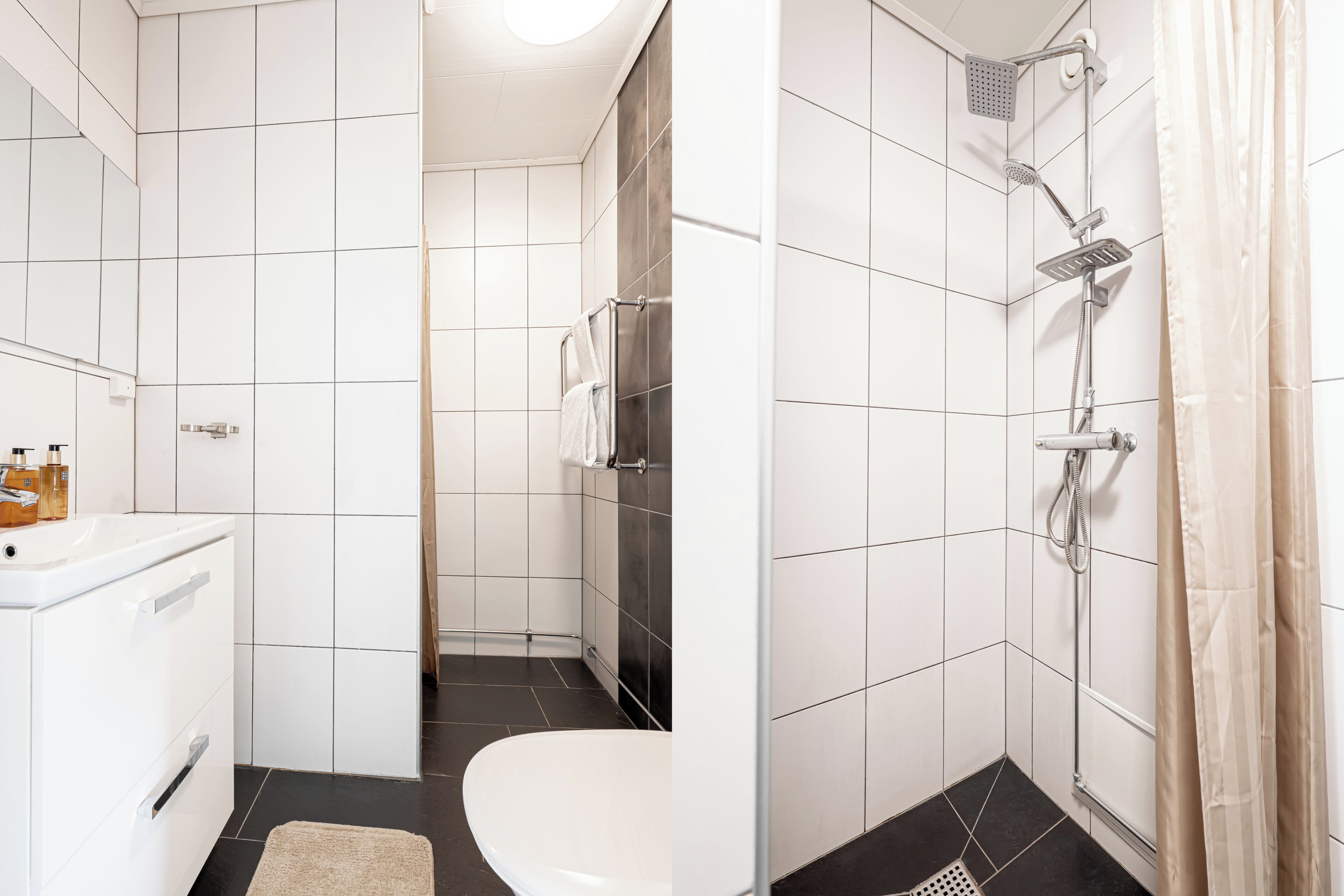 Un baño moderno con inodoro blanco, lavamanos blanco, ducha con cabezal de ducha manual y un perchero para toallas.