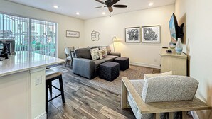 A modern living room with a dining area, a ceiling fan, and artwork on the walls. - Kid-Friendly, themed vacation home close to Disney/Universal (Kissimmee)