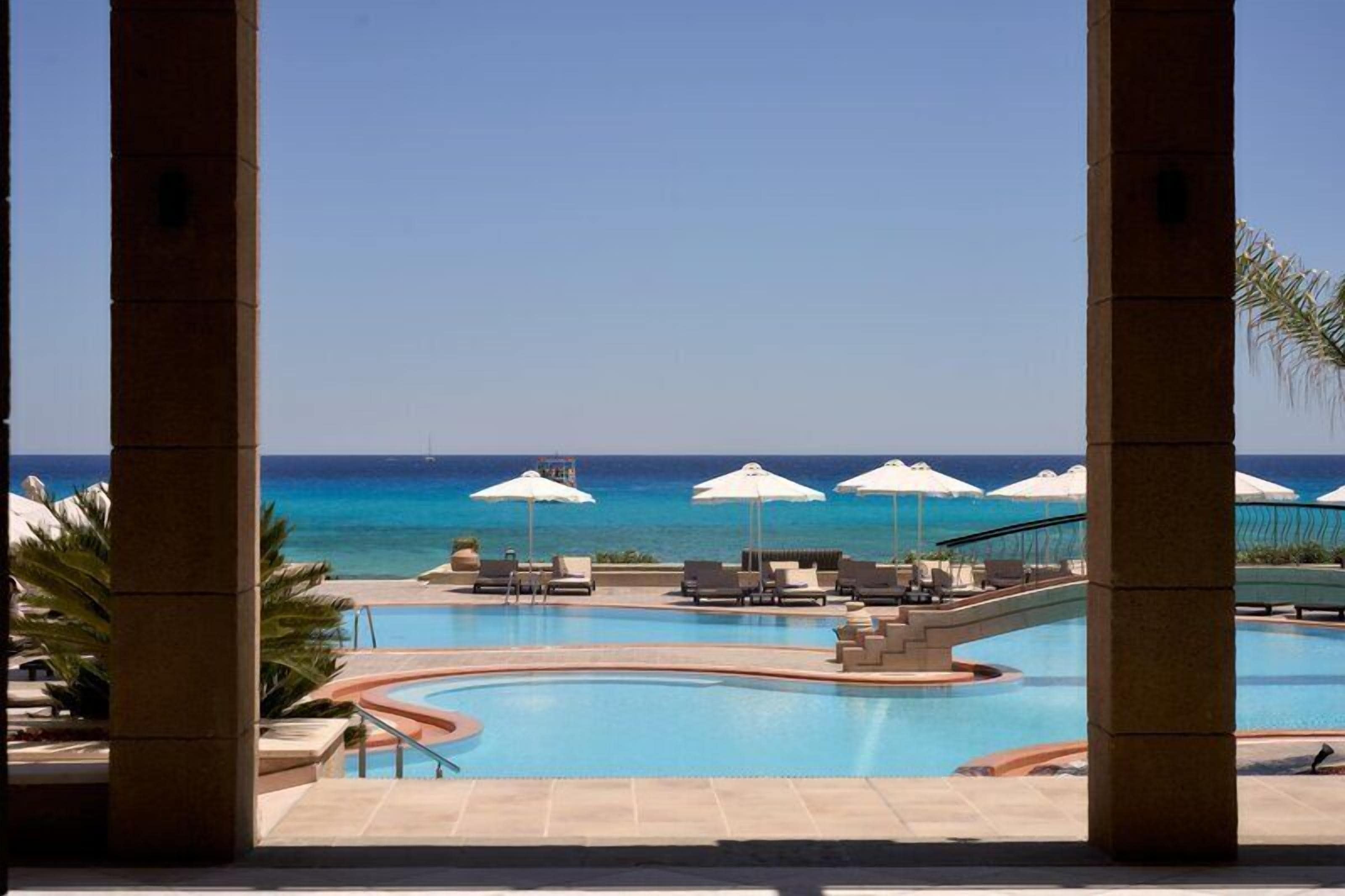 Seasonal outdoor pool, open 10:00 AM to 6:00 PM, pool umbrellas