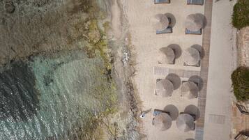 On the beach, sun-loungers, beach umbrellas, beach towels