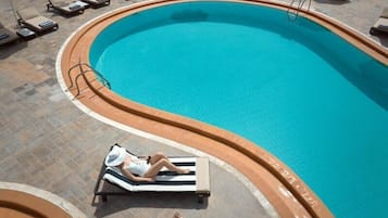 Seasonal outdoor pool, open 10:00 AM to 6:00 PM, pool umbrellas