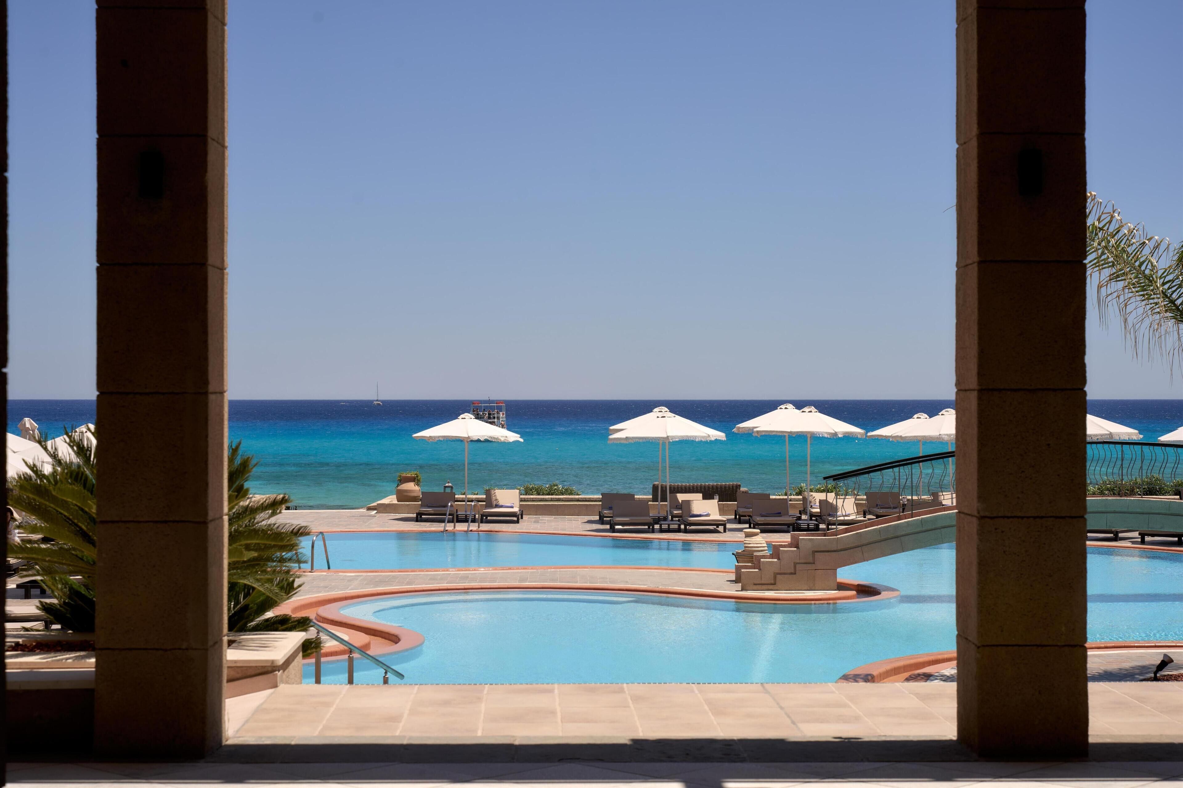 Seasonal outdoor pool, open 10:00 AM to 6:00 PM, pool umbrellas