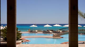 Seasonal outdoor pool, open 10:00 AM to 6:00 PM, pool umbrellas