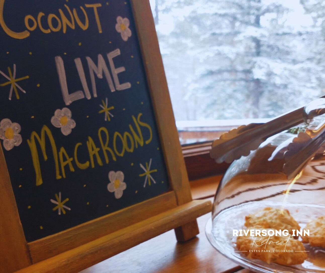 A chalkboard sign with the words "Coconut Lime Macaroons" and a glass display case with macaroons.