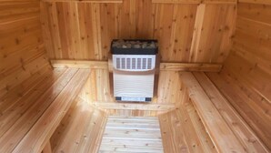 A sauna with a wooden interior, a bench, and a heater. - Priaire Sage Room at RiverSong Inn in Estes Park - Riverside in Rocky Mountain National Park (Estes Park)