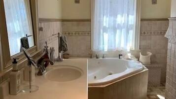 Jetted tub, hair dryer, towels, toilet paper