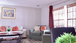A living room with a sofa, armchairs, a coffee table, and a potted plant. - SHADOW WOOD - King Size Private Suite Sleeps 4, Near Universal, I-Drive, Disney (Pine Hills)
