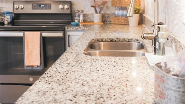 A kitchen with white cabinets, a stainless steel microwave, a gas stove, and a granite countertop. - Cosina. equipped. 6 beds 3 large baths. spaces.  (Live Oak)