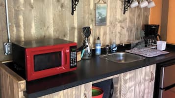 Mini-fridge, microwave, coffee/tea maker, cookware/dishes/utensils