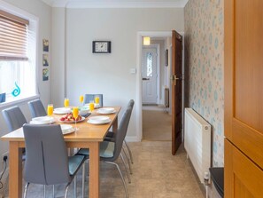 Enjoy meals in this dining area with a table for four and comfortable seating.