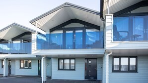 A modern multi-story residential building with large windows and balconies. - 3 Bed pet friendly Beach House with sea views (Westward Ho!)