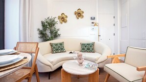 A modern living room with a sofa, chairs, a coffee table, and decorative wall art. - Genteel Home Gamazo Terrace II (Seville)