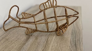 A wicker chair with a curved backrest and armrests.