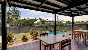 An outdoor patio with a pool, wooden deck, and seating area. - Harper - the perfect holiday home (3 Bedroom) (Mission Beach)