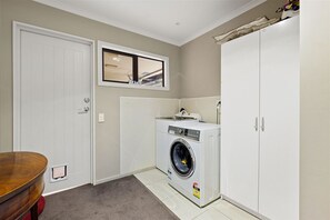 Convenient laundry facilities with a washing machine and dryer.
