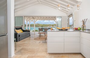 Enjoy a meal at the dining table, with a view of the sea and surrounding landscape from the large balcony.