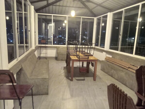 Enjoy dining al fresco with city views from this outdoor space featuring a table, chairs, and bench.