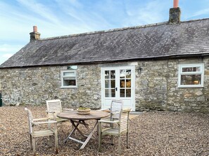 A stone cottage with a tiled roof, a wooden door, and a small window. - 2 bedroom accommodation in Kielder (Kielder)