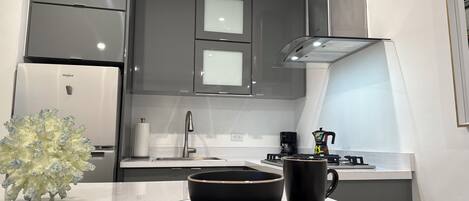 Fridge, stovetop, coffee/tea maker, cookware/dishes/utensils