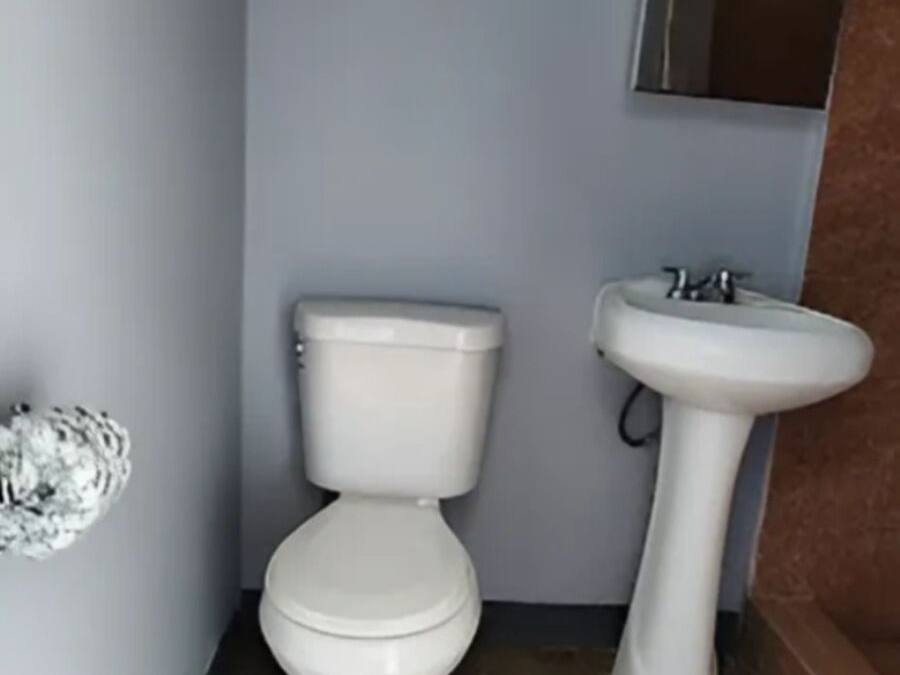 A bathroom with a toilet and a sink.