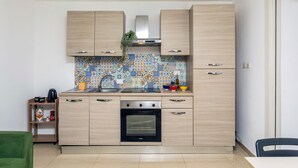 A modern kitchen with wooden cabinets, a tiled backsplash, and a built-in oven.