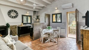 A compact living space with a dining area, kitchen, and a sofa.