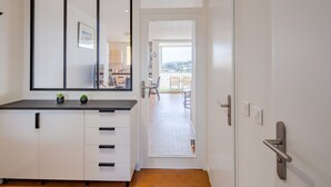 A modern kitchen with white cabinets and a black countertop.
