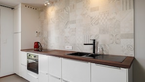 A modern kitchen with a built-in oven, a sink, and a countertop.