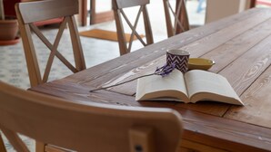 A wooden table with an open book, a patterned mug, and a yellow bowl. - 'Casa Del Cielo' with Sea View, Private Pool and Wi-Fi (Adeje)