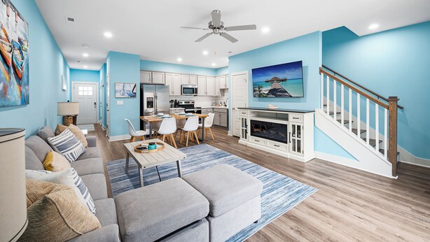 A modern living room with a sofa, ottoman, and a dining area with chairs and a table. - Cozy 3BR/2.5BA Retreat in Nashville/Old Hickory, 20min to Downtown & Airport (Nashville)