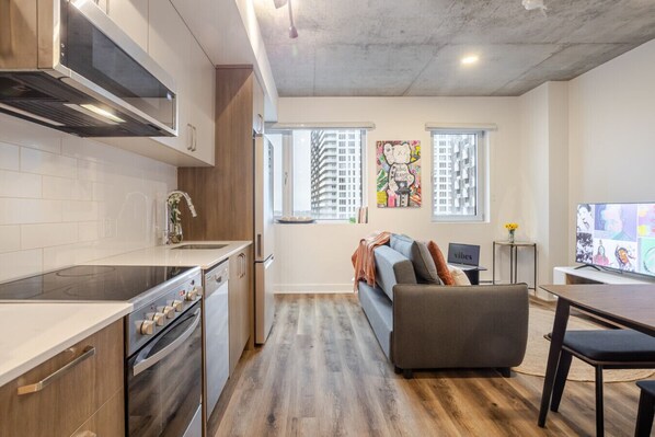 A modern kitchen with a built-in stove, oven, and microwave.