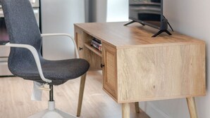 A modern office space with a desk, chair, and a computer.