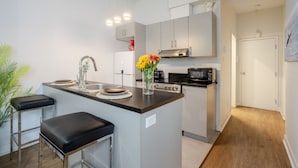A modern kitchen with a central island, stainless steel appliances, and a minimalist design.