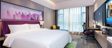 Une chambre d’hôtel moderne équipée d’un grand lit, d’un bureau, d’une chaise et d’un téléviseur.