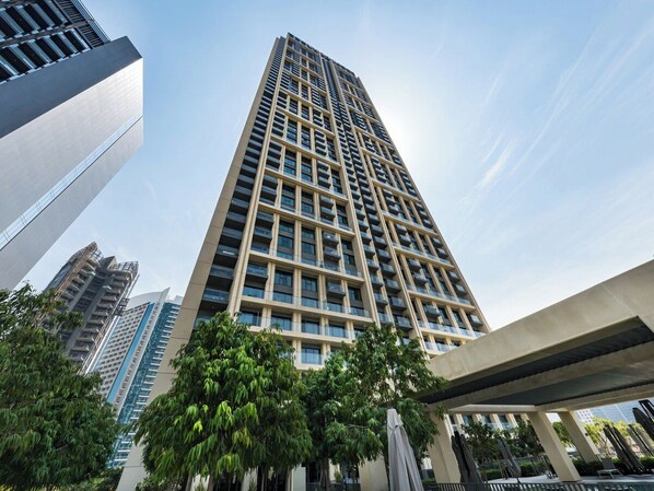 A high-rise building with multiple floors, large windows, and a modern architectural design.
