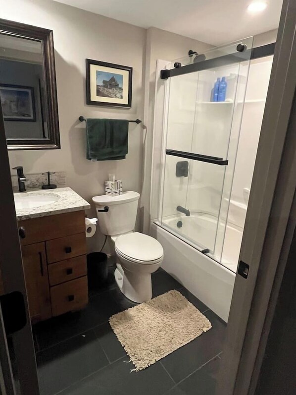 A modern bathroom with a toilet, sink, and shower. - Bridges Resort Mountain Views of Sugarbush (Warren)