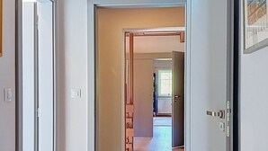 A corridor with wooden flooring leading to a room with a door. - Dolní Lysečiny by Interhome (Horní Maršov/Pec pod Sněžkou)
