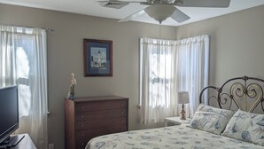 A bedroom with a bed, a dresser, a desk, a ceiling fan, and a framed picture on the wall. - Charming 3-Bedroom Wildwood Crest Spot: Beach, Bay, and Boardwalk- all so close! (Wildwood)