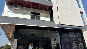A multi-story building with a restaurant named "Radhe Mohan" on the ground floor. - Shree Radhe Mohan Hotel and Resort (Danta Ramgarh)