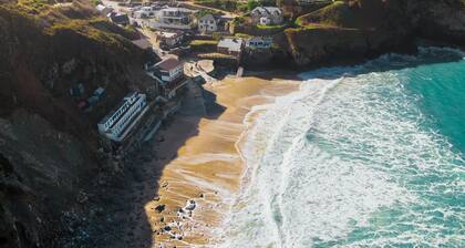 Perched atop the golden sand and rolling waves of Porthtowan Beach