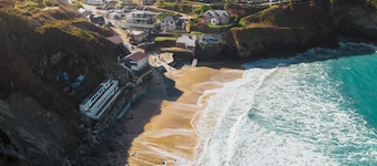 Perched atop the golden sand and rolling waves of Porthtowan Beach